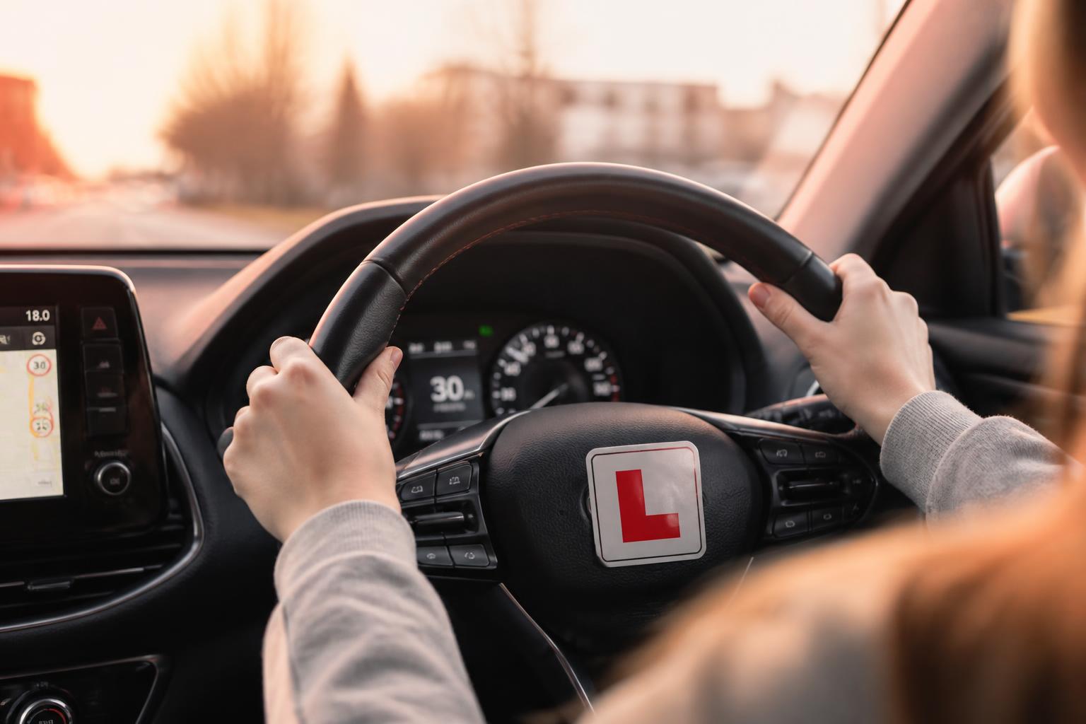 Learner driver's hands on the steering wheel of an automatic car